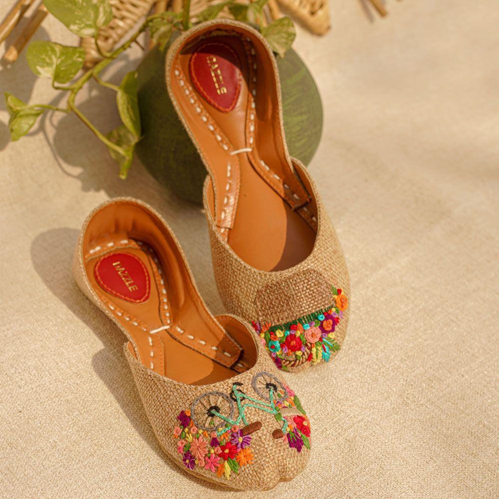 Beige women’s khussa shoes with colorful floral embroidery and bicycle design